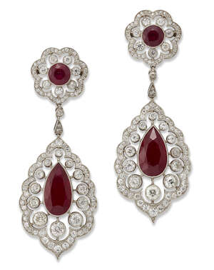 
	
		A pair of platinum, ruby and diamond pendent earrings, each supporting a pear-shaped ruby...