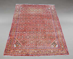 
	
		A large Hamadan woolen carpet, the central reserve decorated with geometric motifs on a...