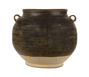 A Chinese grey stoneware jar, Tang dynasty, with wide mouth and two lug handles to shoulders covered in a dark brown glaze stopping above the footrim, 13cm hig