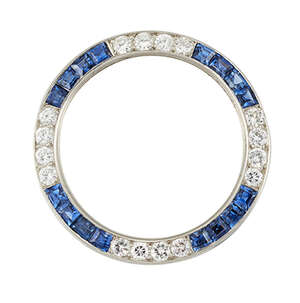 
	
		An Art Deco, diamond and sapphire brooch,  in form of an openwork hoop set alternately...