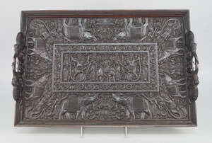 
	
		A carved wood tray. Ceylon, 20th century, carved in shallow relief with a central plaque...