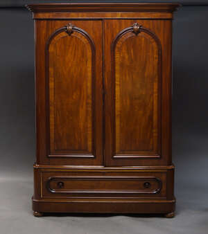 
	
		A Victorian mahogany linen press, the moulded cornice above two arch panelled doors,...