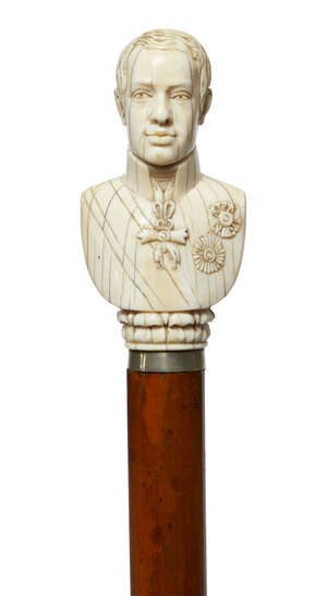 
	
		A Continental ivory walking cane, late 19th century, the handle in the form of a military...