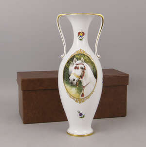 A Herend porcelain twin handled vase, 20th century,  decorated with a portrai of an Arab stallion, with red tasselled head dress, 33.5cm high, in a presentatio