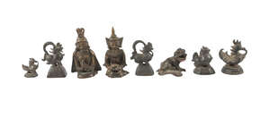 
	
		Eight bronze ornaments, 19th century, comprising of five opium weights, a Buddhist lion,...
