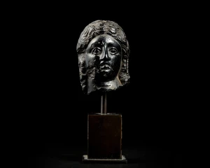 An Egyptian basalt head of a queen or goddessHellenistic, Ptolemaic dynasty, circa 300 - 30...
