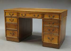 
	
		An oak pedestal desk, early 20th Century, the rectangular top inset with red leather...