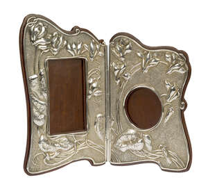 
	
		An Art Nouveau 'Japanesque' silver and mahogany hinged double photograph frame 
		Mark...