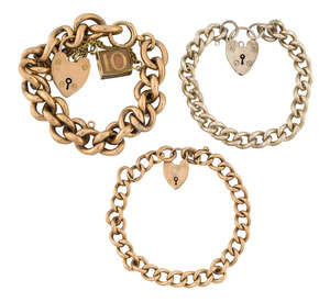 Two early 20th century gold curb link bracelets, the first with 9ct gold padlock clasp and a single 9ct gold mounted 'In Emergency Break Glass' charm w
