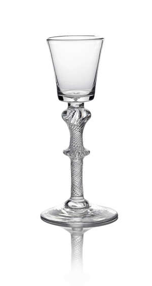 A George II wine glass, c. 1750, the bucket bowl above inverted baluster and bladed knop, air twist stem, on conical foot, 17cm high
		 
		 
