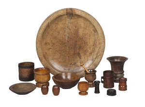 
	
		A collection of treen, mainly 19th century, comprising: two mortars; a pestle; a pair of...