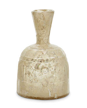 
	
		An Islamic yellowish wheel-cut flask, probably Iran, 9th-10th century, the flaring mouth...
