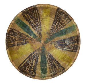 
	
		A Nishapur pottery bowl, Iran, 10th century, underglaze painted in yellow, black and...