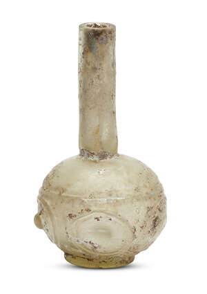 
	
		An Islamic yellowish glass flask, Egypt or Syria, 9th-10th century, made in two parts,...