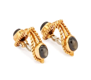 A pair of 18ct gold black star sapphire stirrup cufflinks, each set with two black star sapphire...