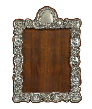 
	
		An Art Nouveau Silver and mahogany photograph frame
		Mark of William Deakin, ...