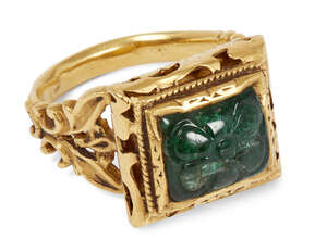 
	
		A carved emerald set gold ring, India, 20th century, the square bezel set with an emerald...