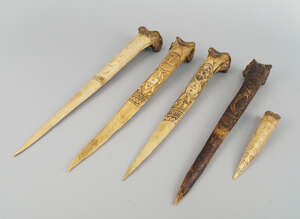 
	
		Five Sepik Cassowary bone daggers, three with carved figural decoration of stylistic male...