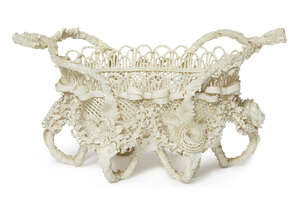 
	
		A Belleek porcelain basket, late 19th century, modelled with twin branch form handles and...