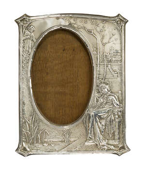
	
		An Edwardian silver and oak photograph frame
		Mark of M. & C. Lister Ltd, Birmingham...