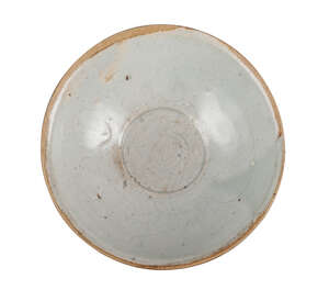 A Chinese porcelain Qingbai glazed bowl, Yuan dynasty, carved to the inside and exterior with stylised floral motifs, flat unglazed base, 16.5cm diameter