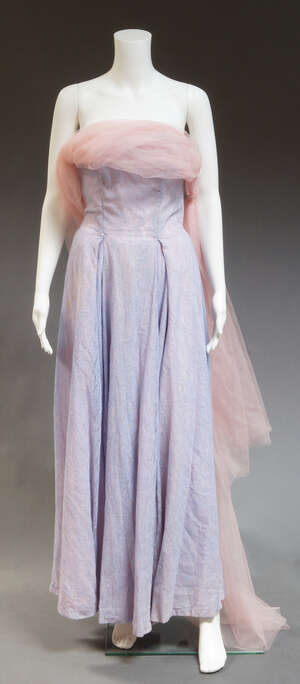 
	
		A 1950s evening gown, the strapless gown of lilac lace over pink under tier, with pink...