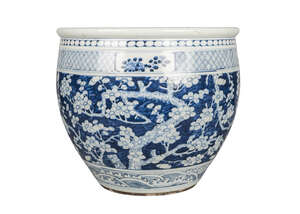 A Chinese porcelain jardiniere, mid-19th century, painted in underglaze blue with blossoming prunus above a border of crashing waves, unglazed, unmarked base, 