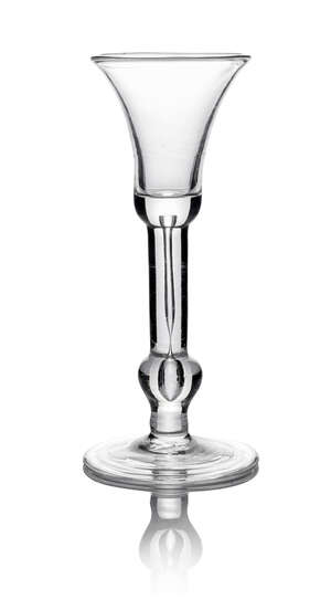 A George II wine glass, c. 1730, with bell form bowl, on extended tear stem, with inverted baluster basel knop, on circular foot, 18.2cm high
		 
		 