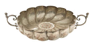 Duchess of Sutherland Cripples Guild, a silver-plated copper twin-handled dish
		c.1910, stamped D.S.C.G with coronet
		Embossed with lobed sides and centred