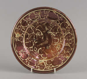 
	
		A Hispanio Moresque pottery plate, 19th century, gilded with a bird within scrolling...