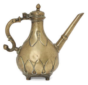 
	
		A small Mughal engraved brass lidded ewer with moulded leaf decoration, India, 18th...