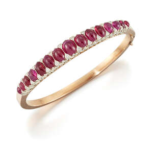 
	
		A late 19th century French, gold, ruby and diamond bangle, the hinged half-hoop set with...