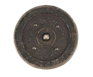
	
		A Chinese bronze circular mirror, Tang dynasty, decorated in low relief with stylised...