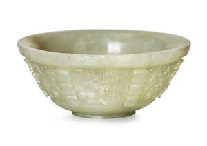 
	
		A small Chinese green jade archaistic bowl, 18th century, finely carved with taotie masks...
