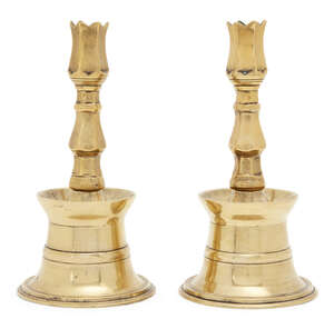 
	
		A pair of Ottoman brass tulip candlesticks, Turkey, 17th/18th century, each rising from a...