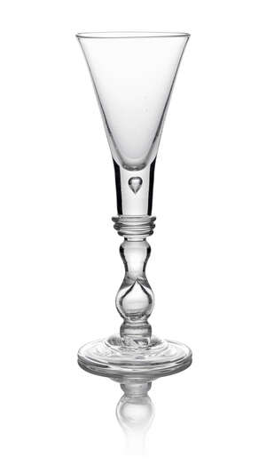 A George II wine glass, c. 1735, with thick based teared trumpet bowl, above triple angulated knop, going into true baluster and inverted baluster knop, on dom