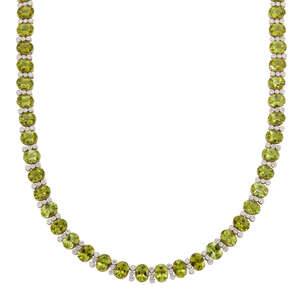 
	
		A peridot and diamond necklace, composed of a line of oval peridots with brilliant-cut...