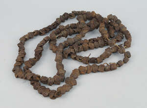 
	
		A large nut necklace, each segment made with shells of ridged form, approximately 208cm...