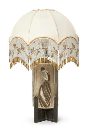 
	
		An Art Deco carved alabaster and bronze mounted table lamp
		c.1925
		The cylinder...