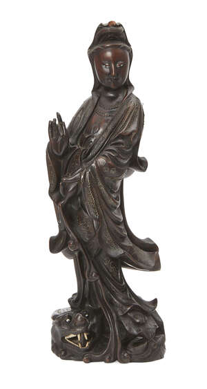 
	
		A Chinese hardwood and wire inlaid figure of Guanyin, late 19th century, carved standing...
