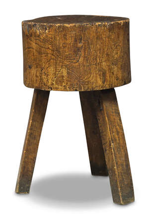 
	
		An elm butchers block, 19th century, the sectional body raised on three square section...