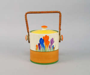 
	
		A Clarice Cliff Crocus pattern biscuit barrel, the cylindrical barrel with wicker handle,...