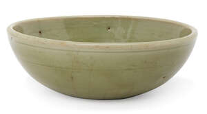 A Chinese Longquan celadon bowl, Ming dynasty, with steep sides and raised central reserve to interior, recessed base with unglazed firing ring revealing burni