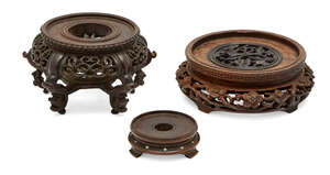 
	
		Three Chinese hardwood stands, 20th century, with pierced and carved decoration, largest...