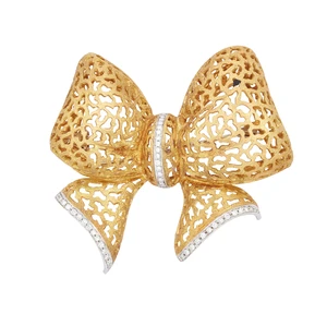 A diamond set bow brooch, the pierced and textured bow with brilliant-cut diamond set lines, to...