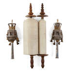 
	
		A miniature 18th century Sefer Torah scroll mounted on carved wooden rollers, possibly...