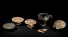 Four ancient pottery vessels, circa 4th Century B.C., including an Apulian black-glazed skyphos...
