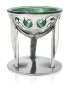 
	
		Archibald Knox (1864-1933) for Liberty & Co, 
		 
		Tudric comport with green glass...
