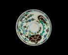 A Kutahya ware pottery saucer, Ottoman Turkey, 19th century, 
with a large aubergine floral...