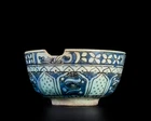 An openwork black, blue and white pottery bowl, possibly Kirman, Iran, 18th century, 
On short...